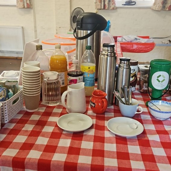 The serving table at Pippa's Community Café, laid out with drinks, cups and saucers